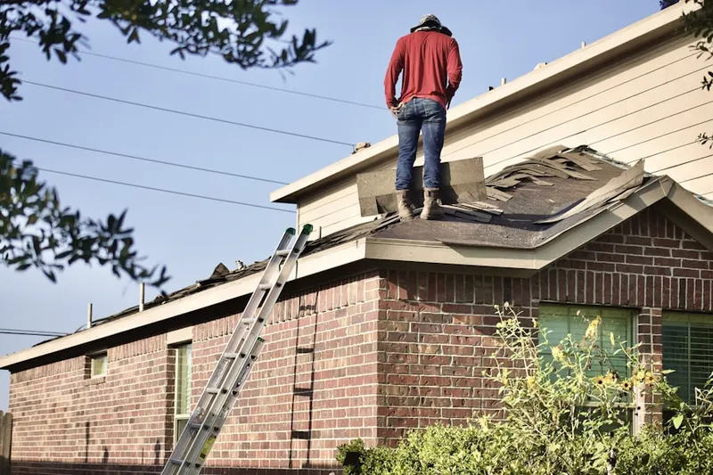 Professional roofer working on a residential roof in Denmark